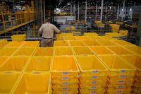 FILE PHOTO: A worker organizes empty bins during Cyber Monday at the Amazon fulfillment center in Robbinsville Township in New Jersey, U.S., November 28, 2022. REUTERS/Eduardo Munoz/File Photo
