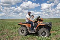 Ryan Christianson, who recently switched internet service from Xplore Inc., formerly Xplornet, to Starlink, Elon Musk’s internet venture, and his son Carter sit for a photograph at this farm near Wadena, SK, June 23, 2023.Photo Liam Richards for the Globe and Mail
