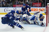 Buffalo Sabres goaltender Craig Anderson (41) stretches to make a save as Toronto Maple Leafs defenceman Timothy Liljegren (37) and Sabres defenceman Jacob Bryson (78) battle during second period NHL hockey action in Toronto on Tuesday, April 12, 2022. THE CANADIAN PRESS/Nathan Denette