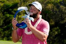 Jon Rahm, of Spain, kisses the champions trophy after the final round of the Tournament of Champions golf event, Sunday, Jan. 8, 2023, at Kapalua Plantation Course in Kapalua, Hawaii. (AP Photo/Matt York)
