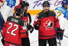 Jack Quinn, left, Lawson Crouse, centre, and Mackenzie Weeger of Canada celebrate a goal during the group B match between Canada and Kazakhstan at the ice hockey world championship in Riga, Latvia, Wednesday, May 17, 2023. (AP Photo/Roman Koksarov)