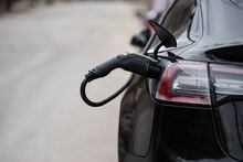 An electric vehicle charger is seen plug into an electric car in Ottawa, Ont. Wednesday, April 13, 2022. Spencer Colby/The Globe and Mail