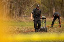 Members of the Six Nations Police conduct a search for unmarked graves using ground-penetrating radar on the 500 acres of the lands associated with the former Indian Residential School, the Mohawk Institute, in Brantford, Ont., Tuesday, November 9, 2021. A panel of Indigenous experts says it will not participate in engagement sessions hosted by an international organization Ottawa hired to provide it with advice on identifying possible human remains in unmarked graves. THE CANADIAN PRESS/Nick Iwanyshyn