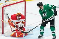 Calgary Flames goaltender Jacob Markstrom (25) blocks a shot by Dallas Stars center Tyler Seguin (91) in the third period of Game 4 of an NHL hockey Stanley Cup first-round playoff series, Monday, May 9, 2022, in Dallas. (AP Photo/Tony Gutierrez)
