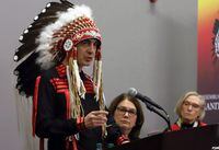 Grand Chief Arlen Dumas, left, speaks during a signing ceremony to improve child and family services in Manitoba First Nations communities, as Indigenous Services Minister Jane Philpot (centre), Northern Affairs Minister Carolyn Bennet look on in Ottawa on Dec. 7, 2017. THE CANADIAN PRESS/Fred Chartrand