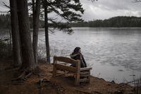 Jennifer Robertson, the widow of QuadrigaCX founder Gerald Cotten, sits on the bench she had made as a memorial to her late husband in their favourite spot the two would walk in Mount Uniacke, N.S. on Wednesday, January 5, 2022. Robertson says she rarely walks there now, opting for other parks due to it being too emotionally difficult.Darren Calabrese/The Globe and Mail