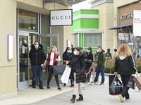 People line up at the Toronto Premium Outlets mall on Black Friday for shopping sales during the COVID-19 pandemic in Milton, Ont., Friday, Nov. 27, 2020. THE CANADIAN PRESS/Nathan Denette