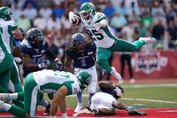 Saskatchewan Roughriders' Jamal Morrow, top right, leaps over Toronto Argonauts' Chris Edwards, bottom right, during first half CFL action at Acadia University in Wolfville, N.S., Saturday, July 16, 2022. Touchdown Atlantic is returning on July 29 with a marquee Canadian Football League matchup. THE CANADIAN PRESS/Darren Calabrese