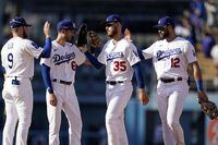 Los Angeles Dodgers' Gavin Lux (9), Trea Turner (6), Cody Bellinger (35) and Joey Gallo (12) celebrate the team's 6-1 win over the Colorado Rockies in a baseball game Wednesday, Oct. 5, 2022, in Los Angeles. (AP Photo/Marcio Jose Sanchez)