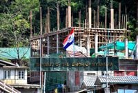 FILE PHOTO: A flag of one of the Myanmar rebel forces is installed next to an under-construction structure in Myanmar's Khawmawi village on the India-Myanmar border as seen from Zokhawthar village in Champhai district of India's northeastern state of Mizoram, India, November 14, 2023. REUTERS/Chanchinmawia/File photo