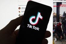 The TikTok logo is seen on a mobile phone in front of a computer screen which displays the TikTok home screen, March 18, 2023, in Boston. The CEO of TikTok dropped into a Ted Talks in Vancouver to address concerns over data security on his social media platform. THE CANADIAN PRESS/AP, Michael Dwyer