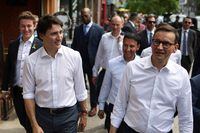 Canadian Prime Minister Justin Trudeau walks with Polish Prime Minister Mateusz Morawiecki along Roncesvalles Avenue, in Toronto, Ontario, Canada, June 2, 2023. REUTERS/Carlos Osorio