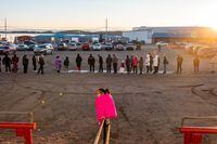 Iqaluit residents line up outside of Nakasuk Elementary School to get bottled water donated by the City of Iqaluit on October 15, 2021.