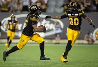 Hamilton Tiger-Cats wide receiver Alex Green celebrates one of his touchdowns with teammate Terrence Toliver (80), The Ticats beat the Toronto Argonauts 42-28 in their traditional Labour Day game.