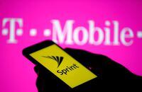 FILE PHOTO: A smartphone with Sprint logo are seen in front of a screen projection of T-mobile logo, in this picture illustration taken April 30, 2018. REUTERS/Dado Ruvic/Illustration/File Photo
