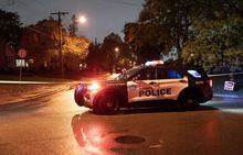 Police block the road at the scene of a shooting where a suspect shot at officers in Toronto, on Tuesday, Oct 18, 2022. The Toronto Police Service says they have made an arrest after a suspect inside a home shot at officers. THE CANADIAN PRESS/Arlyn McAdorey
