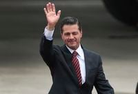 Mexico's President Enrique Pena Nieto waves after arriving at the Ministro Pistarini international airport to attend the G20 Summit in Buenos Aires, Argentina, Thursday, Nov. 29, 2018. Leaders from the Group of 20 industrialized nations will meet in Buenos Aires for a two-day summit starting Friday. (AP Photo/Martin Mejia)
