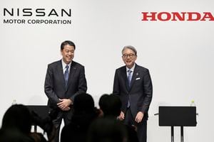 Nissan Chief Executive Makoto Uchida, left, and Honda President Toshihiro Mibe attend a joint news conference in Tokyo, Friday, March 15, 2024. Nissan and Honda announced Friday that they will work together in developing electric vehicles and auto intelligence technology, sectors where Japanese automakers have fallen behind. (Kyodo News via AP)