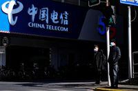 A sign of China Telecom is seen on a street, during the coronavirus disease (COVID-19) outbreak in Shanghai, China January 8, 2021. REUTERS/Aly Song