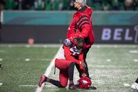 Calgary Stampeders defensive back Jamar Wall (29) kneels in dejections after the team's loss to the Saskatchewan Roughriders in overtime CFL football action in Regina, Sunday, Nov. 28, 2021. THE CANADIAN PRESS/Kayle Neis