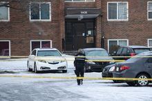 Police investigate the scene where two officers were shot and killed on duty in Edmonton on Thursday, March 16, 2023. THE CANADIAN PRESS/Jason Franson