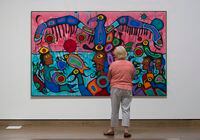 A woman surveys the painting "Copper Thunderbird" by Norval Morrisseau on display during a media tour of the National Gallery of Canada's Canadian and Indigenous Galleries featuring Canadian and Indigenous Art: From Time Immemorial to 1967 in Ottawa, Wednesday, June 7, 2017. THE CANADIAN PRESS/Adrian Wyld