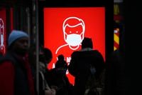 A government digital poster encouraging people to wear face masks to curb the spread of coronavirus, is displayed in a bus stop in London, Friday, Dec. 17, 2021. After the U.K. recorded its highest number of confirmed new COVID-19 infections since the pandemic began, France announced Thursday that it would tighten entry rules for those coming from Britain. Hours later, the country set another record, with a further 88,376 confirmed COVID-19 cases reported Thursday, almost 10,000 more than the day before. (AP Photo/Matt Dunham)