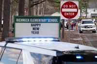 Police respond to a shooting at Richneck Elementary School in Newport News, Va., on Friday, Jan. 6, 2023. Police say a 6-year-old student shot and wounded a teacher at the school during an altercation inside a first-grade classroomwld. (Billy Schuerman/The Virginian-Pilot via AP)