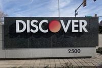 RIVERWOODS, ILLINOIS - FEBRUARY 19: A sign sits at the entrance of the Discover Financial Services corporate headquarters campus on February 19, 2024 in Riverwoods, Illinois. Capital One plans to buy Discover Financial Services, a deal that would merge two of the nation's largest credit-card companies. (Photo by Scott Olson/Getty Images)