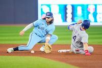 TORONTO, ON - SEPTEMBER 14: Robbie Grossman #4 of the Texas Rangers steals second base ahead of the tag by Bo Bichette #11 of the Toronto Blue Jays in the fifth inning at Rogers Centre on September 14, 2023 in Toronto, Canada. (Photo by Mark Blinch/Getty Images)