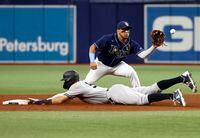 May 26, 2022; St. Petersburg, Florida, USA;  New York Yankees right fielder Aaron Judge (99) steals second base as Tampa Bay Rays shortstop Isaac Paredes (17) attempts to tag him out during the sixth inning at Tropicana Field. Mandatory Credit: Kim Klement-USA TODAY Sports