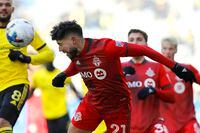 Toronto FC midfielder Jonathan Osorio heads the ball during the second half of an MLS soccer match against the Columbus Crew on Saturday, March 12, 2022, in Columbus, Ohio. (AP Photo/Joe Maiorana)