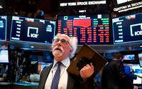 In this March 16, 2020 file photo, trader Peter Tuchman works on the floor of the New York Stock Exchange.