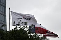 FILE PHOTO: Flags fly outside ConocoPhillips offices in Houston, Texas, U.S., April 30, 2019.  REUTERS/Loren Elliott/File Photo