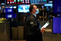Traders work on the floor of the New York Stock Exchange at the opening bell on Feb. 22.