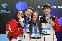 Team Canada’s Pamela Ware, left to right, Bryden Hattie, Caeli McKay and Nathan Zsombor-Murray, celebrate their silver medal following the mixed team event final at the World Aquatics Diving World Cup 2023 in Montreal, Sunday, May 7, 2023. THE CANADIAN PRESS/Christinne Muschi