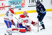 Montreal Canadiens goaltender Carey Price (31) saves the tip by Winnipeg Jets' Pierre-Luc Dubois (13) as Jeff Petry (26) defends during third period NHL playoff action in Winnipeg on Friday, June 4, 2021. THE CANADIAN PRESS/John Woods 