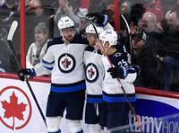 Winnipeg Jets left wing Kyle Connor (81) celebreats his goal against the Ottawa Senators with left wing Pierre-Luc Dubois (80) and centre Paul Stastny (25) during third period NHL hockey action in Ottawa, Sunday, April 10, 2022. THE CANADIAN PRESS/Justin Tang