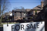 A for sale sign is shown in front of west-end Toronto homes Sunday, April 9, 2017. The Canadian Real Estate Association is cutting its forecast for home sales this year and lowering its expectations for price growth. THE CANADIAN PRESS/Graeme Roy