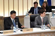 China's President Xi Jinping (L) and Canada's Prime Minister Justin Trudeau attend the session on women's workforce participation, future of work, and ageing societies, at the G20 Summit in Osaka, Japan,  June 29, 2019. Kazuhiro Nogi/Pool via REUTERS
