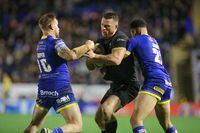 Toronto Wolfpack forward Adam Sidlow (centre) is tackled in a Feb. 21, 2020, Super League game against the Warrington Wolves at the Halliwell Jones Stadium in Warrington, England.