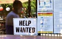 (FILES) In this file photo taken on May 28, 2021, a 'Help Wanted' sign is posted beside Coronavirus safety guidelines in front of a restaurant in Los Angeles, California. - The US added just 210,000 jobs last month, the government reported on Dcember 3, 2021,, less than half the increase analysts were expecting, raising questions about the health of the economic recovery. The unemployment rate nonetheless declined more than expected, falling four-tenths to 4.2 percent, the Labor Department reported. (Photo by Frederic J. BROWN / AFP) (Photo by FREDERIC J. BROWN/AFP via Getty Images)