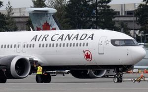 An Air Canada jet is moved on the tarmac at the airport, Wednesday, Nov.15, 2023 in Vancouver.