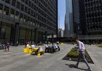 People have lunch on side of the Toronto Dominion Centre on Wednesday, May 10, 2023. Tuan Minh Nguyen/ The Globe and Mail