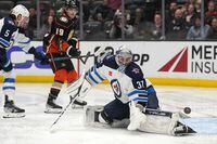 Mar 23, 2023; Anaheim, California, USA; Winnipeg Jets goaltender Connor Hellebuyck (37) makes a save against the Anaheim Ducks in the second period at Honda Center. Mandatory Credit: Kirby Lee-USA TODAY Sports