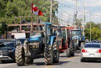 People driving tractors protest at a scheduled event with Canada's Prime Minister Justin Trudeau that was cancelled in Embrun, Ontario, Canada, July 15, 2022.  REUTERS/Patrick Doyle