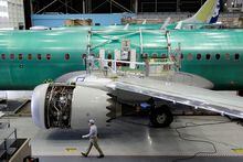 FILE PHOTO: A worker walks past Boeing's new 737 MAX-9 under construction at their production facility in Renton, Washington, U.S., February 13, 2017. Picture taken February 13, 2017. REUTERS/Jason Redmond