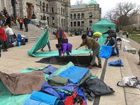 Protesters gather their belongings as they pack up their camp at the British Columbia legislature grounds in Victoria, B.C., on Thursday, March 5, 2020.