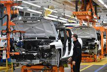In this file photo taken on November 17, 2021 GMC Hummer EVs are seen on an assembly line ahead of a tour by the US president of the General Motors Factory ZERO electric vehicle assembly plant in Detroit
