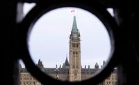 The Parliament Hill Peace Tower is framed in an iron fence on Wellington Street in Ottawa on Thursday, March 12, 2020. An annual survey on how trusting Canadians are suggests their faith in governments is rebounding as the COVID-19 pandemic begins to fade. THE CANADIAN PRESS/Sean Kilpatrick